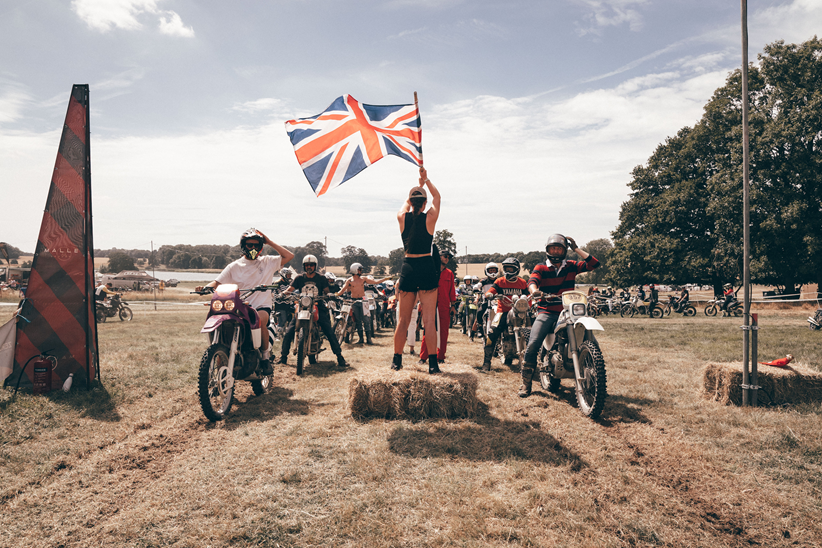 A group of racers waiting at a union jack on a hot summers day