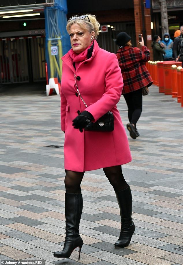Out and about: Eddie Izzard, 59, showcased her eye-catching sense of style in a fuchsia pink coat and stiletto heeled boots as she headed out for a stroll in London's Chinatown on Friday
