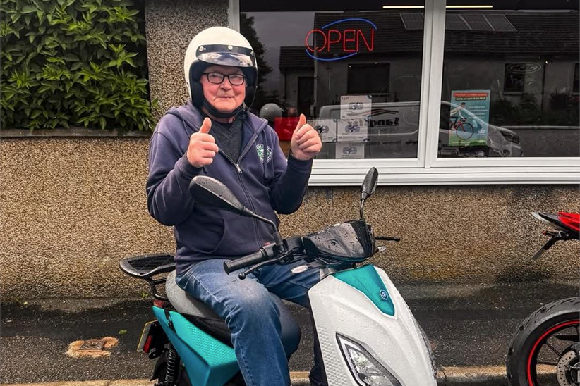 Peter Ewing outside AMS Motorcycles in Wick on his new electric bike